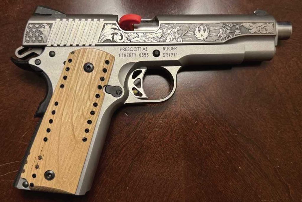 A commemorative Ruger 1911 features custom grips hand-carved by Terry Fant from reclaimed USS Constitution deck planks.