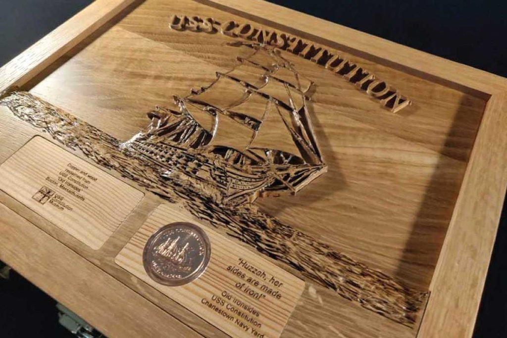Master craftsman Glen Dean created this solid oak chest, featuring a detailed carving of Old Ironsides and naval-inspired relief work.
